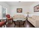 Cozy living room features hardwood floors and natural lighting at 5285 Winflow Way, Suwanee, GA 30024