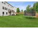 Expansive backyard with a large grassy area, trampoline, and a patio dining set at 6360 Boulder Rdg, Cumming, GA 30028
