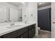 Bathroom with a double sink vanity, large mirror, and shower/tub combo with grey curtain at 6360 Boulder Rdg, Cumming, GA 30028