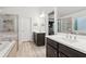 Luxurious bathroom with a soaking tub, tiled shower, and dual vanities at 6360 Boulder Rdg, Cumming, GA 30028