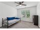 Neutral bedroom with a metal-framed daybed, side shelving, carpeted floor, and bright window at 6360 Boulder Rdg, Cumming, GA 30028