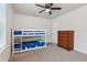 Cozy bedroom features a bunk bed with star-patterned sheets, ceiling fan, and wooden dresser at 6360 Boulder Rdg, Cumming, GA 30028