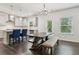 Dining area showcasing a farmhouse-style table and easy access to the modern kitchen at 6360 Boulder Rdg, Cumming, GA 30028