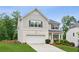 Charming two-story home with a manicured lawn and a two-car garage, offering curb appeal at 6360 Boulder Rdg, Cumming, GA 30028