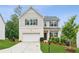 Charming two-story home with a manicured lawn and a two-car garage, offering curb appeal at 6360 Boulder Rdg, Cumming, GA 30028