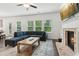 Comfortable living room with large sectional sofa, fireplace, and ample natural light at 6360 Boulder Rdg, Cumming, GA 30028