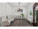 Well-lit living room featuring hardwood floors, classic furniture, and neutral paint at 6360 Boulder Rdg, Cumming, GA 30028