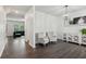 Open-concept living area featuring hardwood floors, lots of space and bright neutral paint at 6360 Boulder Rdg, Cumming, GA 30028