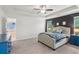 Bright main bedroom with trey ceiling, dark accent wall, plush carpet, and ensuite bath at 6360 Boulder Rdg, Cumming, GA 30028