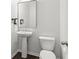 Elegant half-bathroom featuring modern fixtures and a sleek pedestal sink at 6360 Boulder Rdg, Cumming, GA 30028