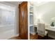 Beautiful bathroom featuring tub with glass door and separate vanity/desk area with a rustic sliding barn door at 1101 Juniper Ne St # 632, Atlanta, GA 30309
