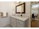 Well-lit bathroom with a large mirror, vanity with storage, and view into the dining area at 1101 Juniper Ne St # 632, Atlanta, GA 30309
