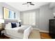 Comfortable bedroom with hardwood floors, shuttered windows, and a ceiling fan at 1101 Juniper Ne St # 632, Atlanta, GA 30309