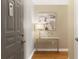 Inviting entryway featuring a gray door, artwork, a decorative table, and wood floors for a welcoming ambiance at 1101 Juniper Ne St # 632, Atlanta, GA 30309