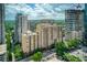 An urban high-rise condominium building with greenery and an open parking lot; construction visible in the background at 1101 Juniper Ne St # 632, Atlanta, GA 30309