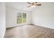 Serene bedroom with a ceiling fan, new floors, and ample natural light from the large window at 1104 Driftwood Ct, Mcdonough, GA 30252