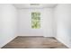A vacant room has wood-look flooring and a window with nature views at 1104 Driftwood Ct, Mcdonough, GA 30252