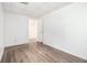 A vacant bedroom features wood-look flooring and an adjacent doorway at 1104 Driftwood Ct, Mcdonough, GA 30252