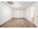 A spacious vacant bedroom with wood-look flooring and an adjacent doorway at 1104 Driftwood Ct, Mcdonough, GA 30252