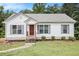 Charming single-story home featuring a well-maintained lawn, neutral siding, and a cozy front porch at 1104 Driftwood Ct, Mcdonough, GA 30252