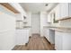 Bright kitchen featuring white cabinets, granite countertops, and new wood flooring at 1104 Driftwood Ct, Mcdonough, GA 30252