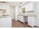 Bright kitchen featuring white cabinets, granite countertops, and new wood flooring at 1104 Driftwood Ct, Mcdonough, GA 30252