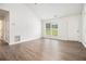 Bright living room offering new floors, neutral walls, and a large window for a clean and modern aesthetic at 1104 Driftwood Ct, Mcdonough, GA 30252