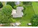 Aerial shot of a home highlighting the roof, large yard, driveway, and lush greenery at 2055 Cactus Ln, Cumming, GA 30040
