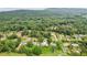 A sprawling, green landscape surrounds this charming home near a dense forest and distant hills at 2055 Cactus Ln, Cumming, GA 30040