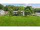 Large, grassy backyard featuring a neutral-colored home with a wood deck and mature trees at 2055 Cactus Ln, Cumming, GA 30040