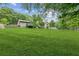 Spacious backyard with a well-maintained lawn and a house featuring a wooden deck at 2055 Cactus Ln, Cumming, GA 30040
