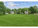 Expansive, well-maintained backyard showcasing a house with a deck and surrounding trees at 2055 Cactus Ln, Cumming, GA 30040