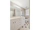 Bathroom showcasing a vanity with ample storage, a large mirror, and a combination tub and shower at 2055 Cactus Ln, Cumming, GA 30040