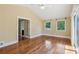 Bedroom with hardwood floors, ceiling fan, vaulted ceiling, and French doors leading to an outdoor balcony at 2055 Cactus Ln, Cumming, GA 30040