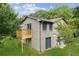 View of a charming home with a small wooden deck and basement entrance at 2055 Cactus Ln, Cumming, GA 30040