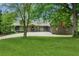 Ranch-style home with beautiful landscaping, mature trees, and a long driveway at 2055 Cactus Ln, Cumming, GA 30040