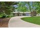 Ranch-style home with three-car garage, manicured landscaping and an asphalt drive at 2055 Cactus Ln, Cumming, GA 30040