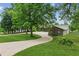 Landscaped front yard with mature trees and an extra-long asphalt driveway at 2055 Cactus Ln, Cumming, GA 30040