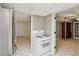 Open view of kitchen and bonus room, white gas range, stainless fridge and tile floor at 2055 Cactus Ln, Cumming, GA 30040