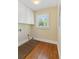 Laundry room features hardwood floors, window and washer/dryer hookups at 2055 Cactus Ln, Cumming, GA 30040