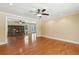 Open-concept living room with hardwood floors and a stone fireplace feature at 2055 Cactus Ln, Cumming, GA 30040