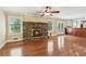 Spacious living room with hardwood floors, stone fireplace, ceiling fan, and lots of natural light at 2055 Cactus Ln, Cumming, GA 30040