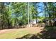 Spacious backyard featuring a new fence and mature trees offering privacy and shade at 2745 Saxon Drive, Duluth, GA 30096