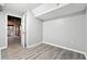 Finished basement area with light gray walls and wood-look floors leading to a garage at 2745 Saxon Drive, Duluth, GA 30096