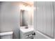 Half bathroom with new vanity and mirror, accented with stylish lighting at 2745 Saxon Drive, Duluth, GA 30096
