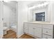 Updated bathroom with double sink vanity and marble-look tiled shower/tub at 2745 Saxon Drive, Duluth, GA 30096