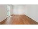 Bright, empty room with wood-look flooring, neutral walls, and natural light from the window at 2745 Saxon Drive, Duluth, GA 30096
