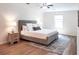 Cozy bedroom with neutral decor, ceiling fan, wood floors, and a geometric patterned rug at 2745 Saxon Drive, Duluth, GA 30096