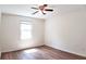 Bedroom featuring wood floors, ceiling fan, and a window with wooden blinds at 2745 Saxon Drive, Duluth, GA 30096