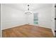 Bright dining room with wood flooring and a modern chandelier at 2745 Saxon Drive, Duluth, GA 30096